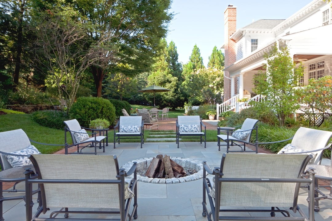 Traditional backyard patio and fire pit with concrete pavers