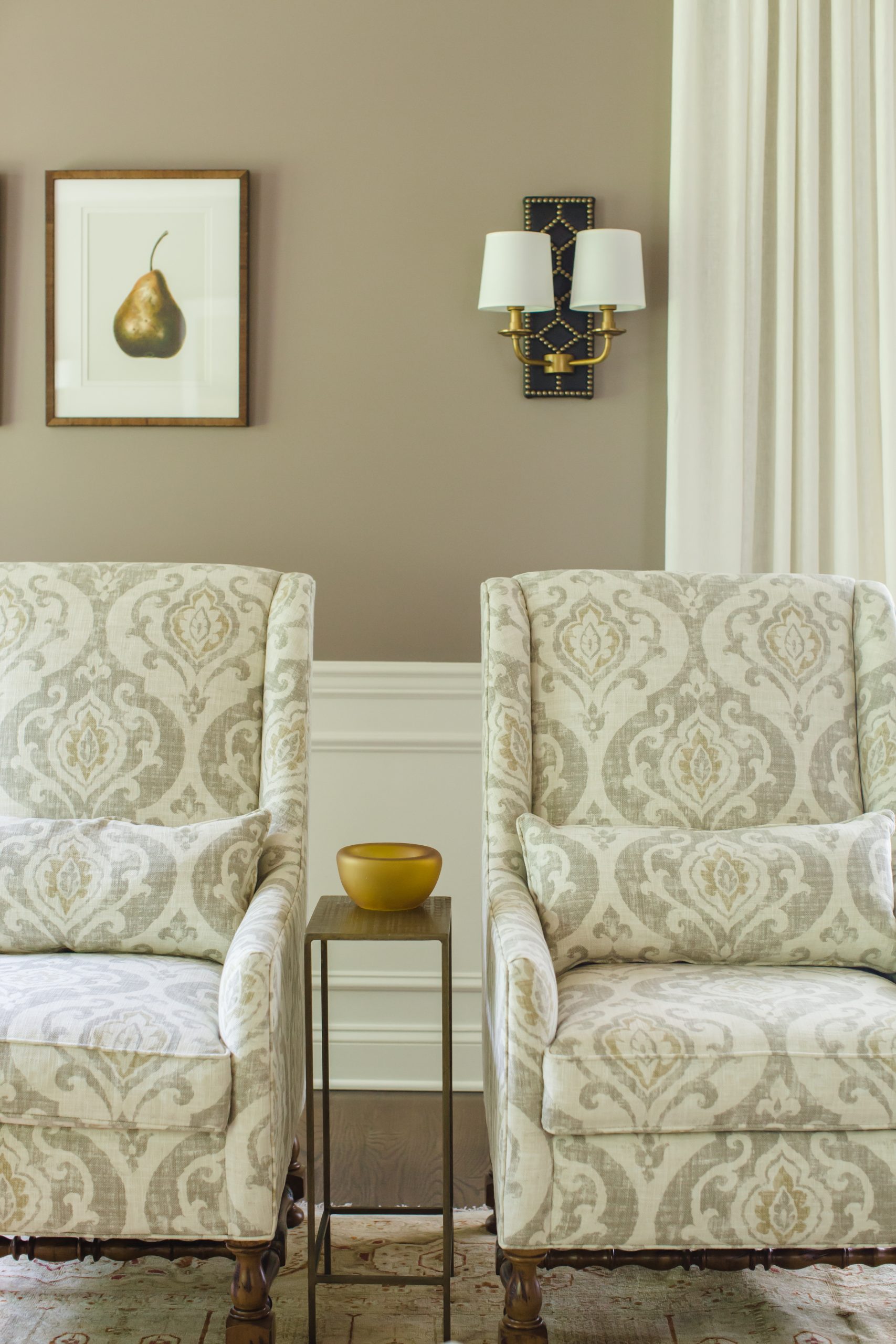 Decorative twin light cream armchairs with small wooden side table (Zoomed in)