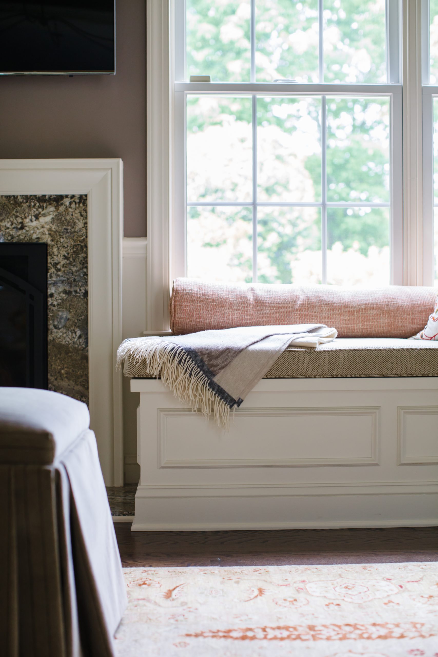 Transitional windowsill bench with white molding and beige cushion