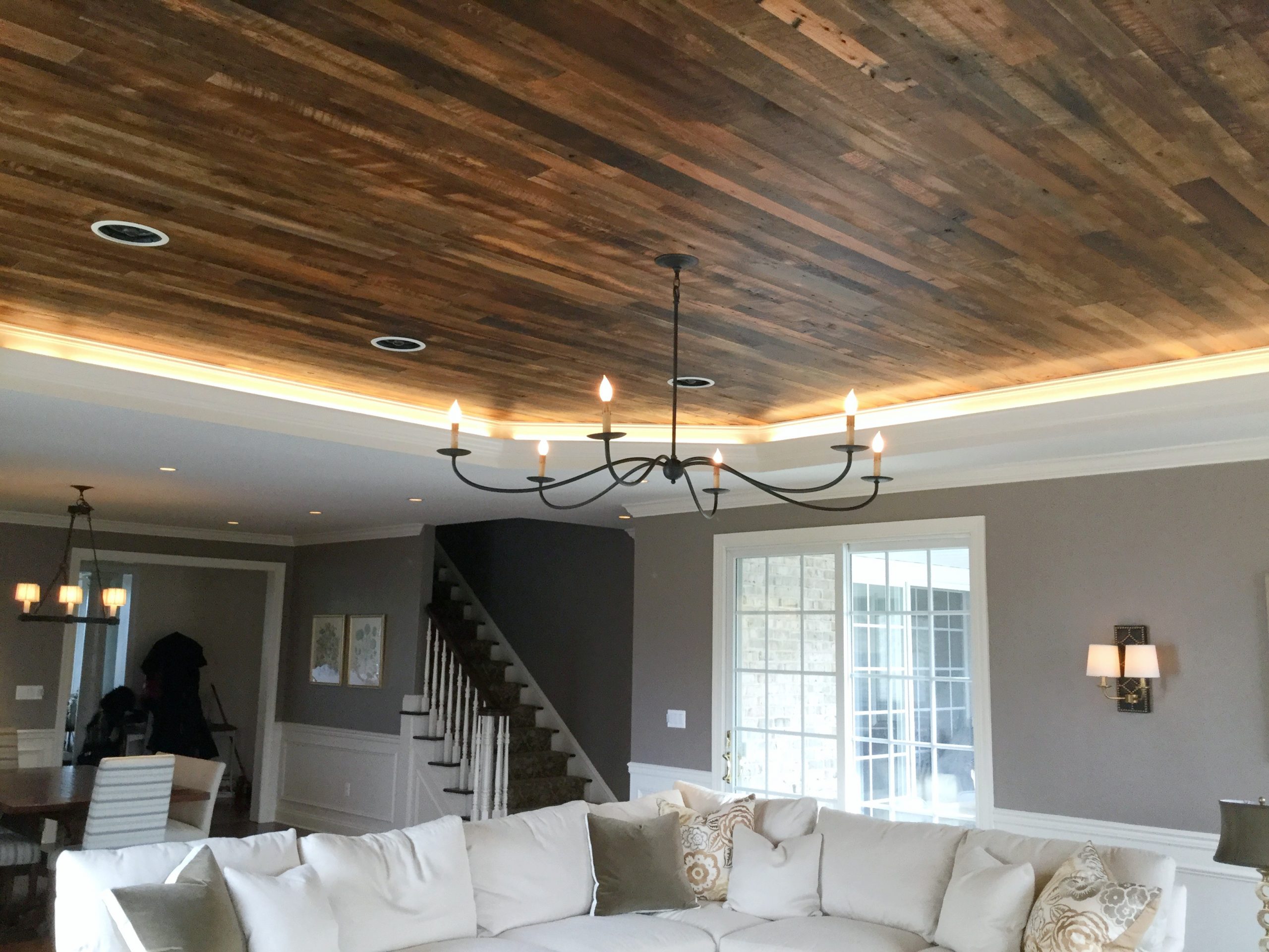 Custom black metal chandelier on dark hardwood panel ceiling