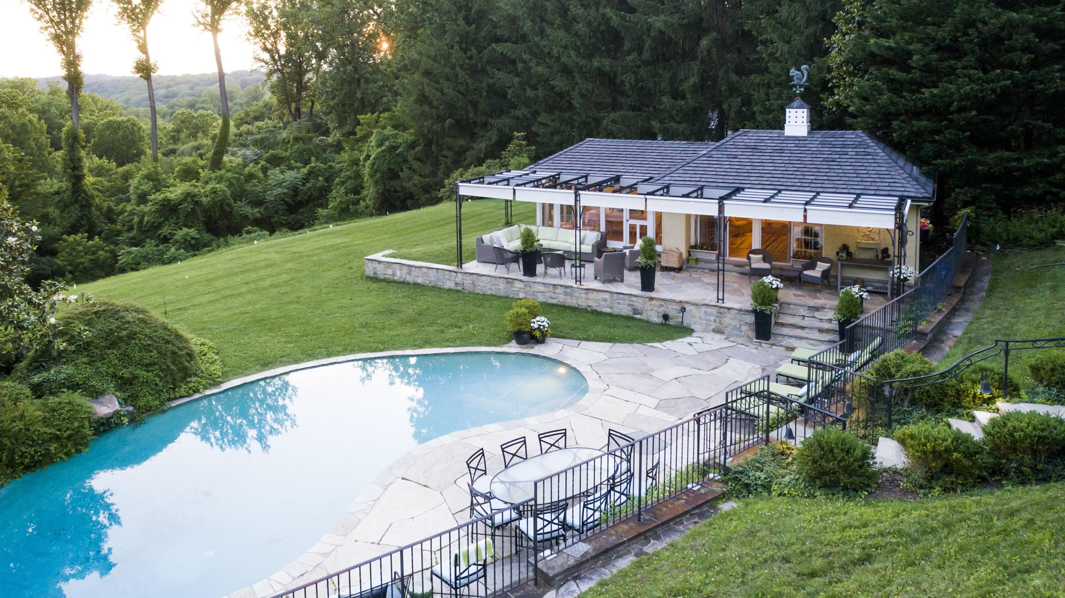 Luxury pool house custom designed for a home remodel with a large seating space and large metal pergola (House side view) (3)