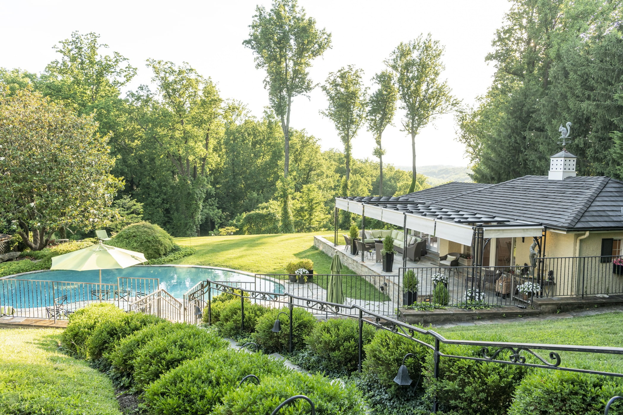 Luxury pool house custom designed for a home remodel with a large seating space and large metal pergola (House side view) (2)