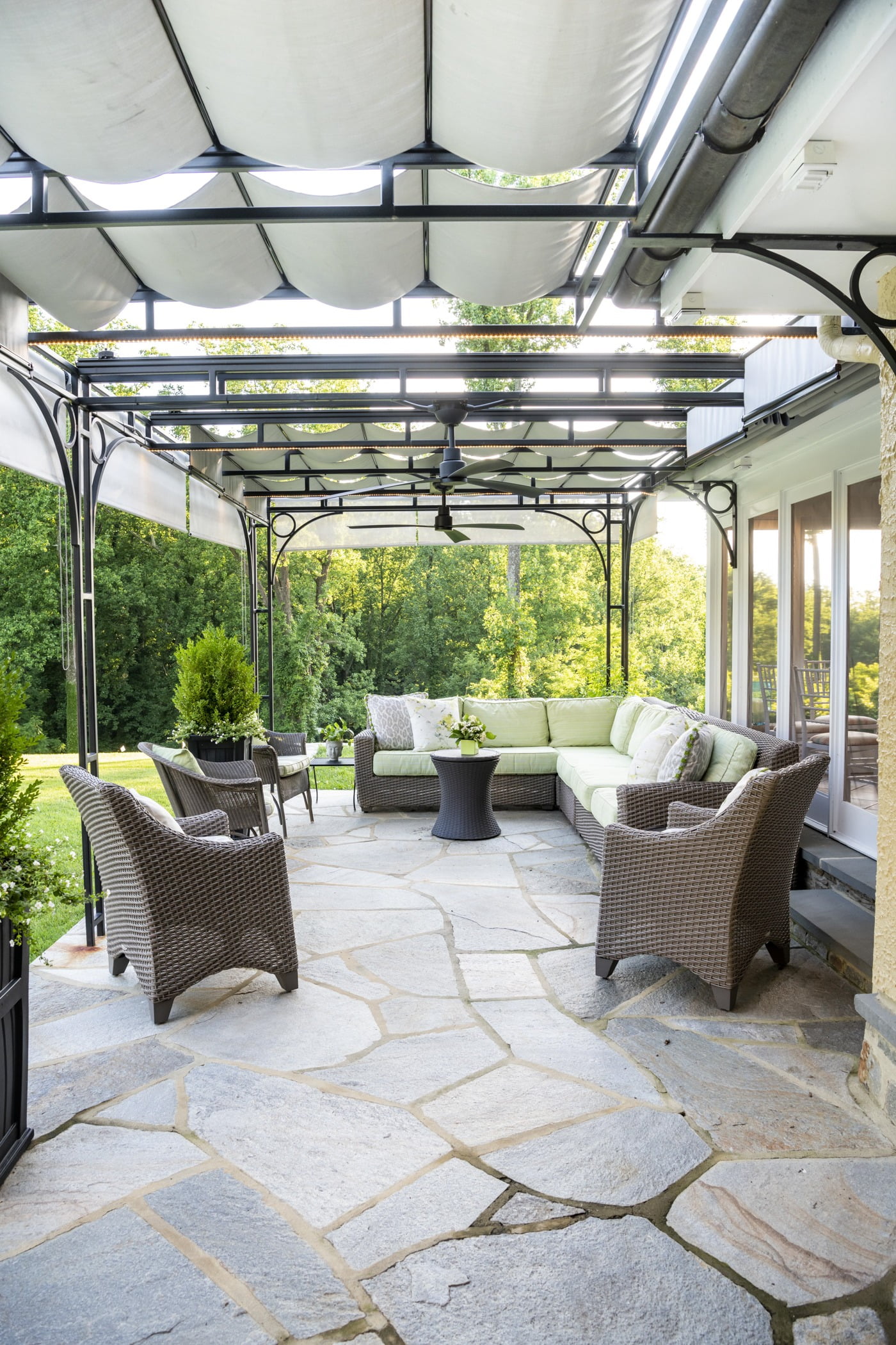 Luxury outdoor pool house space with a couch and retractable ceiling (closed)