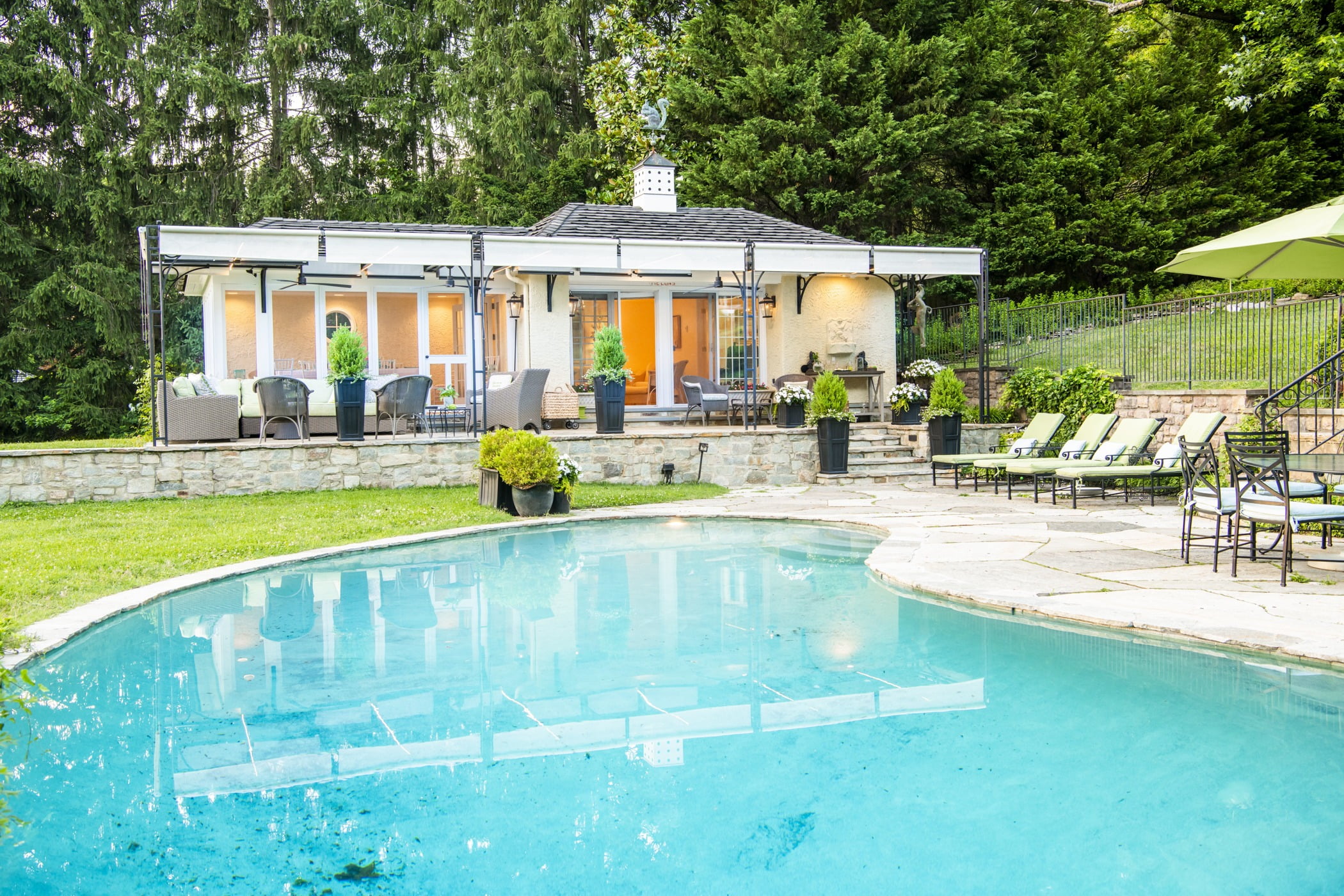 Luxury pool house custom designed for a home remodel with a large seating space and large metal pergola (Pool view) (2)