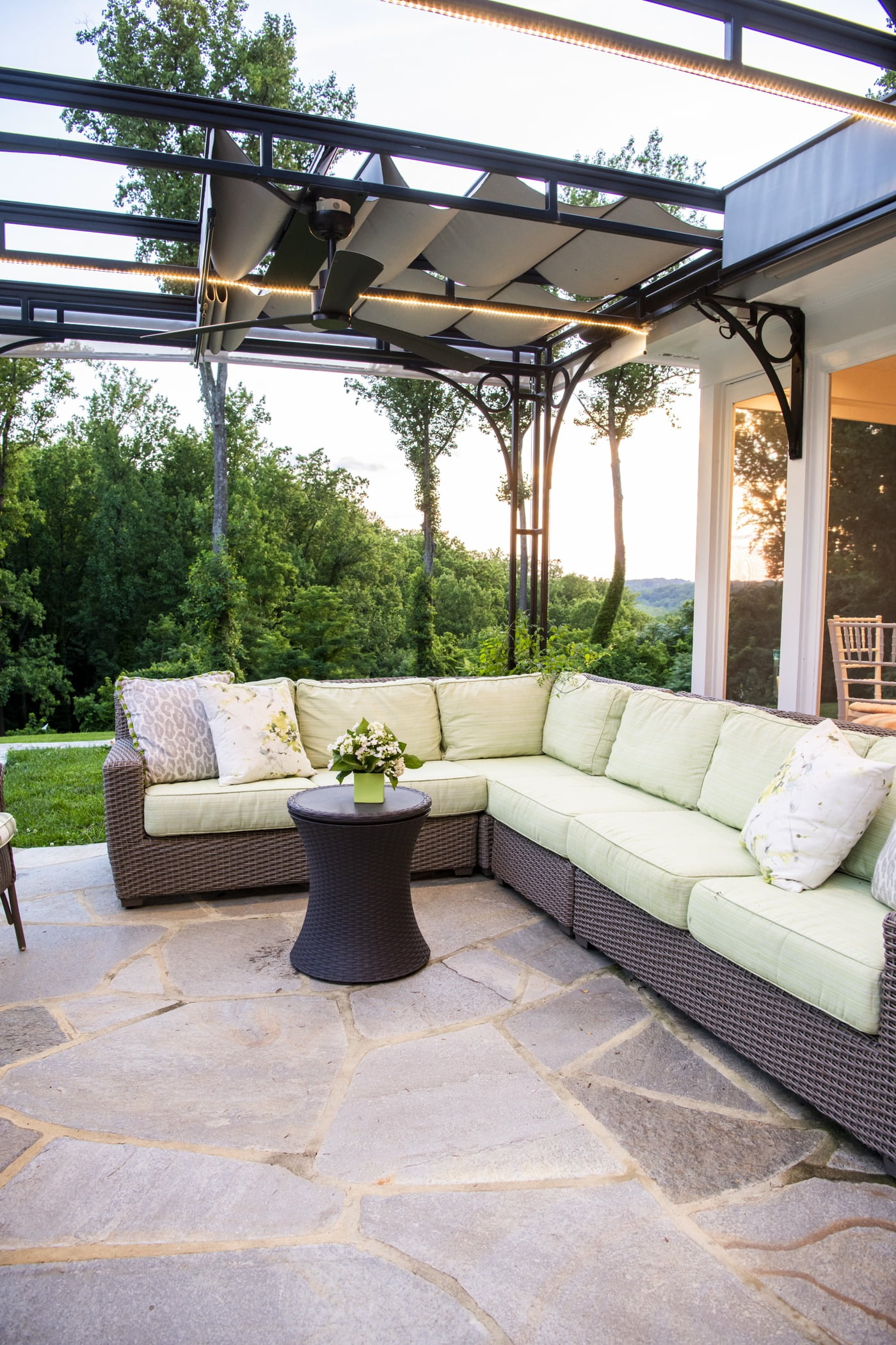 Luxury outdoor pool house space with an outdoor couch and retractable ceiling (3)