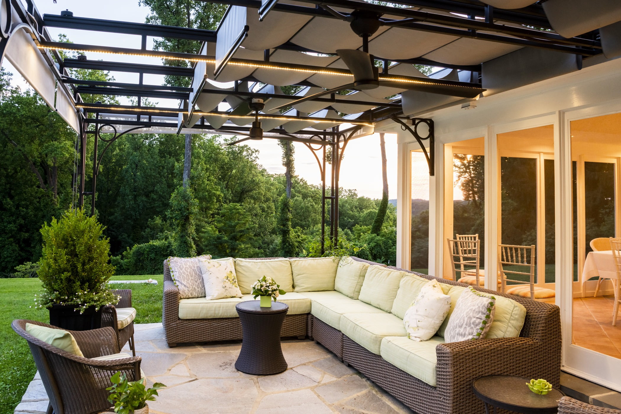 Luxury outdoor pool house space with an outdoor couch and retractable ceiling (2)