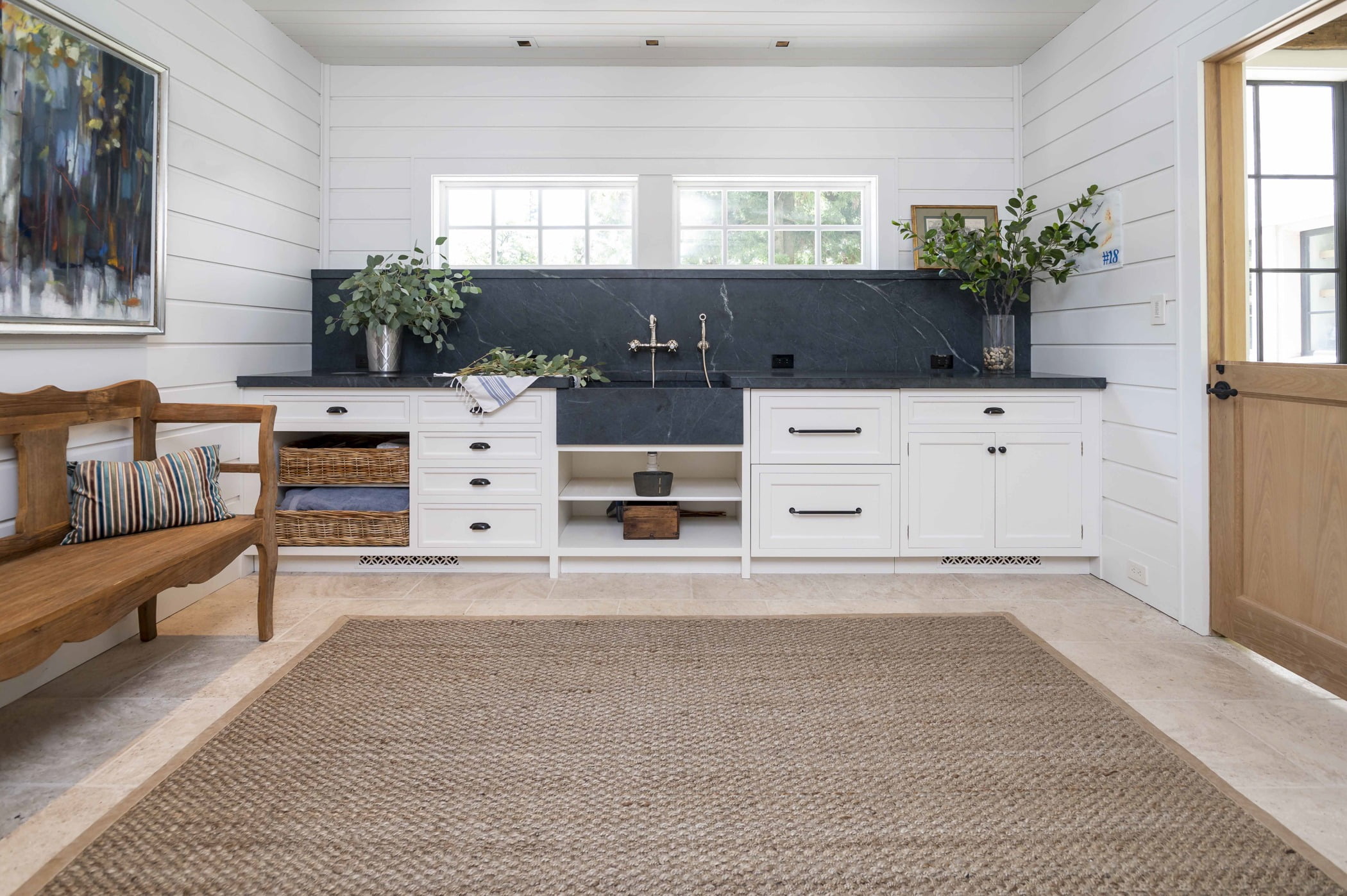 Transitional sink/washroom space with white cabinetry, grey-blue countertops, and white paneling on walls and ceiling