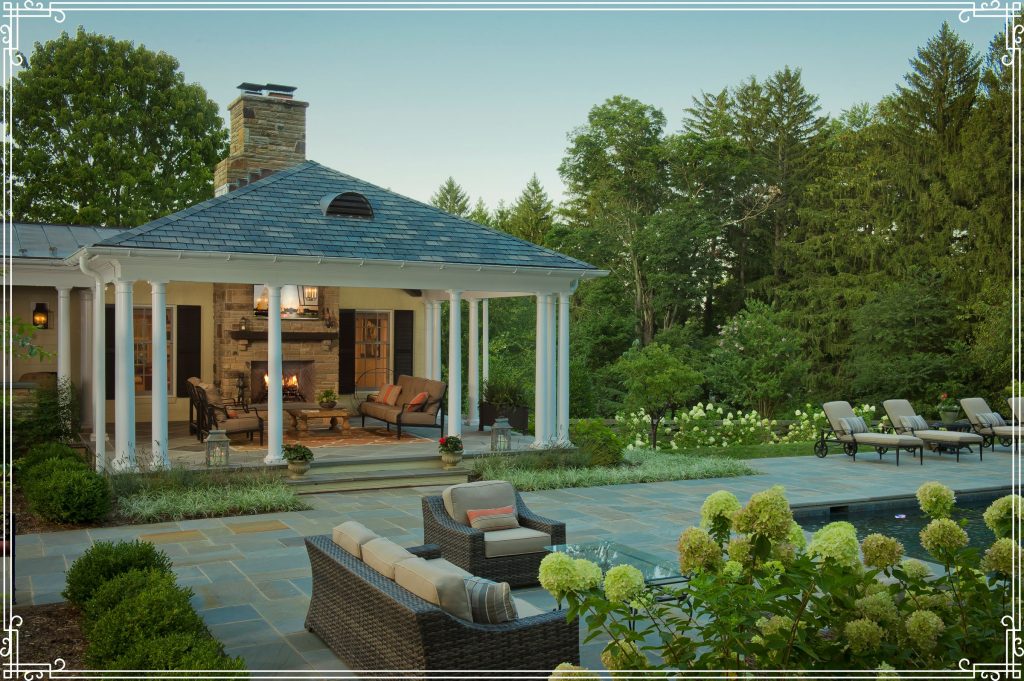 Transitional backyard patio and pool, with multicolored concrete pavers, and a covered seating area with tv and fireplace