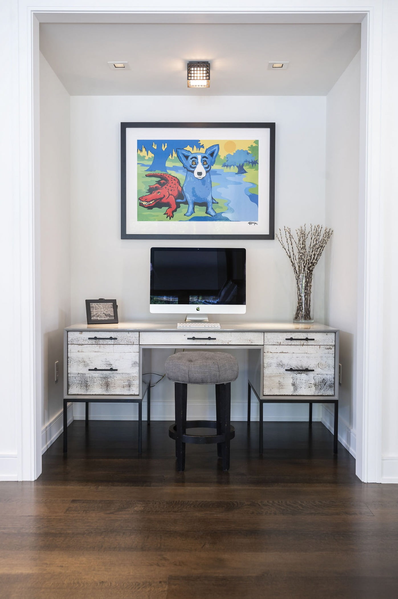 Contemporary desk with unstained wood cabinetry, wooden pouf stool, and dark hardwood flooring