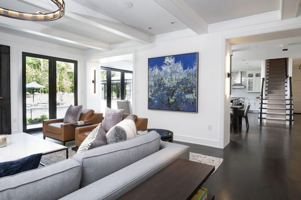 Modern family room with dark hardwood flooring and cabinetry, all white wall color (Different view)