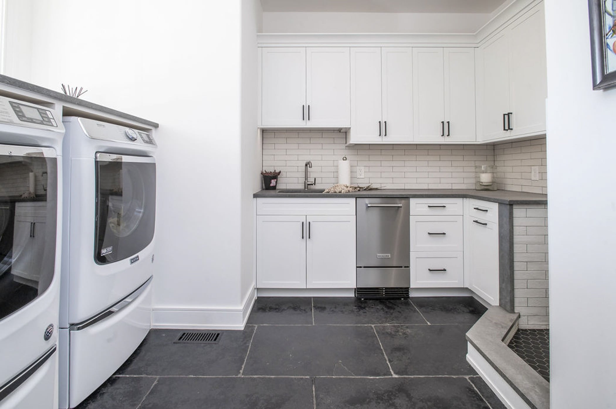 Remodeled mudroom with a kitchenette, white cabinetry, gray countertops and a small dog shower (Different view)