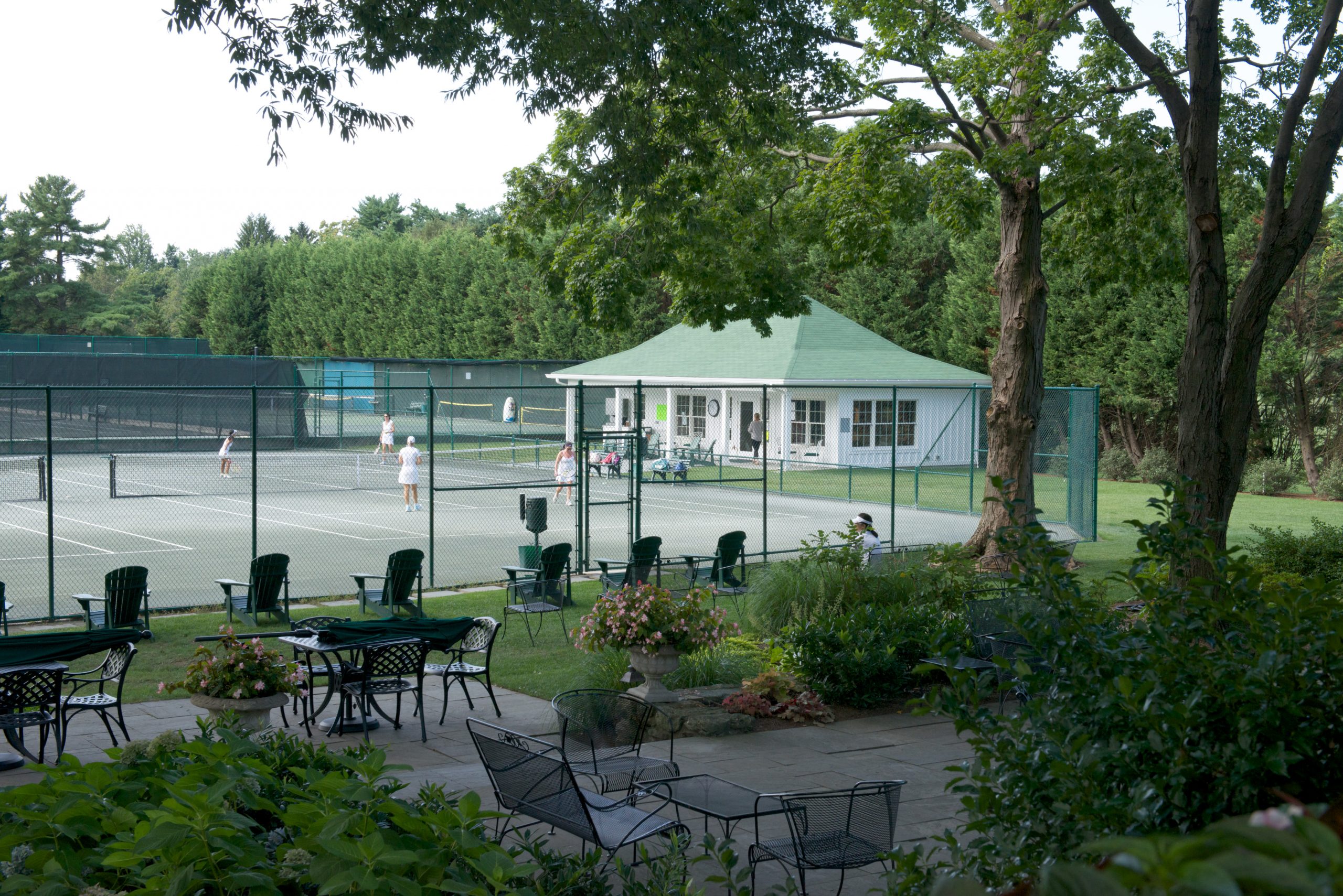 The tennis court and outdoor seating area at Elkridge Country Club in Baltimore, Maryland renovated by Delbert Adams Construction Group, Commercial Construction division.